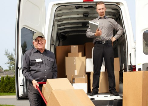 Furniture pickup team removing bulky items from an Earls Court flat