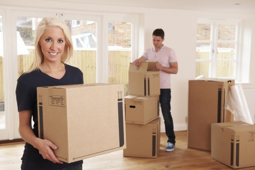 Movers carrying furniture through an Earls Court office building