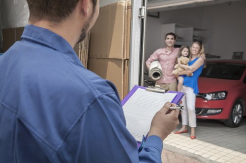 Student removals team helping with boxes in an Earls Court flat