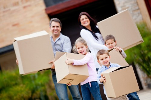 Local movers carrying furniture down stairs in Earls Court