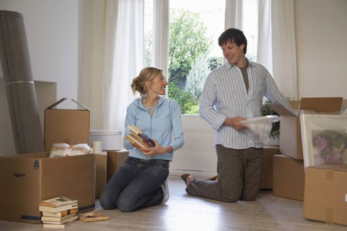 Careful lifting of household items in a London flat move