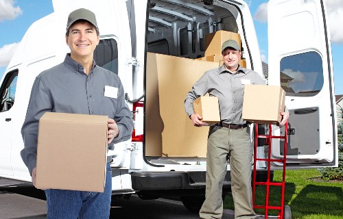 Professional movers loading household items for an Earls Court home removal