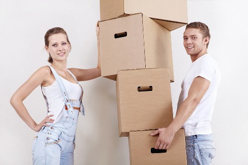 Local movers handling office boxes in a London commercial property
